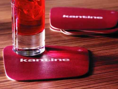 red cocktail served on a square beer mat