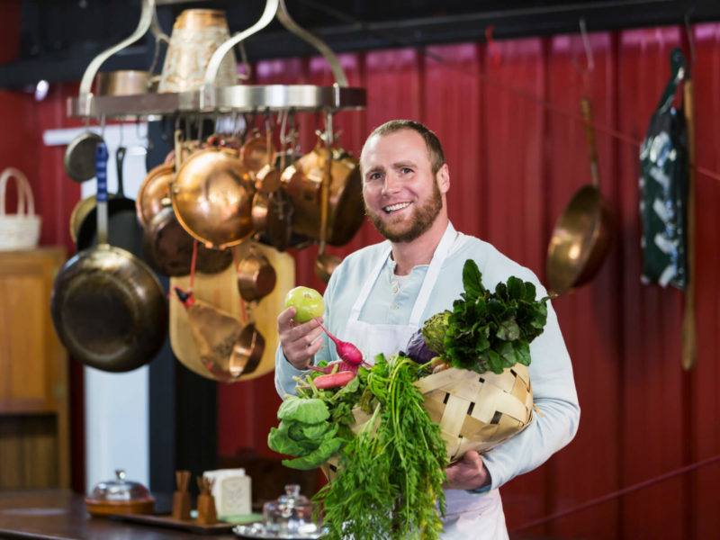 sustainable dining chef with fresh produce in his resturant