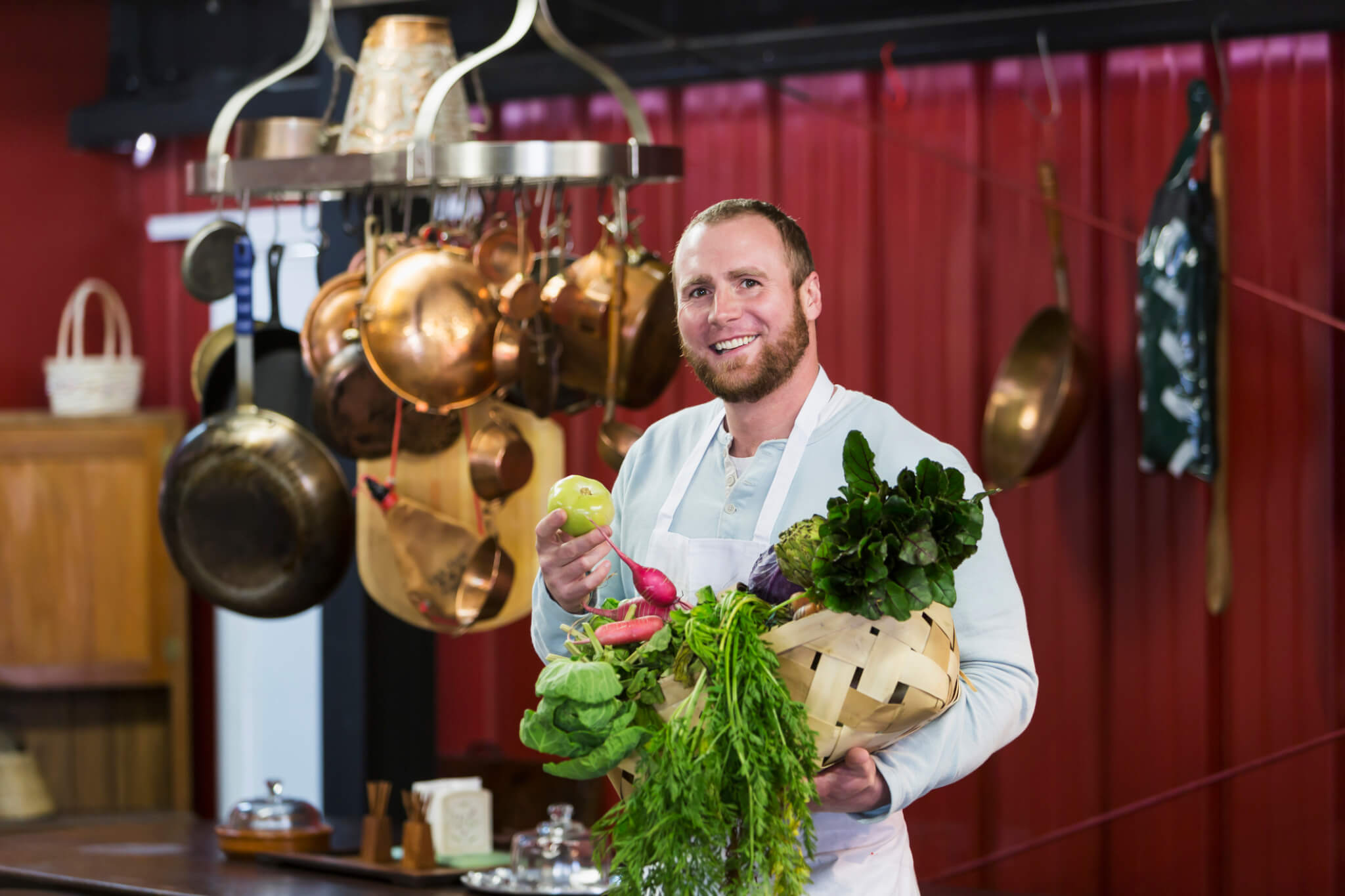 sustainable dining chef with fresh produce in his resturant